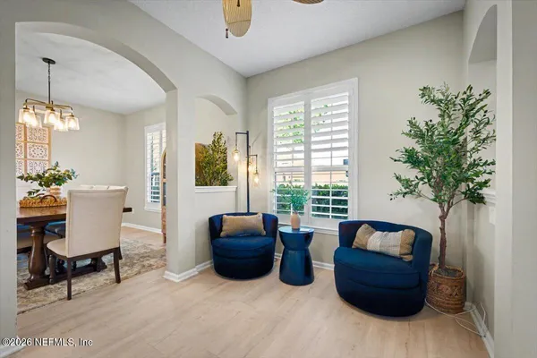 a view of a dining room with furniture and chandelier