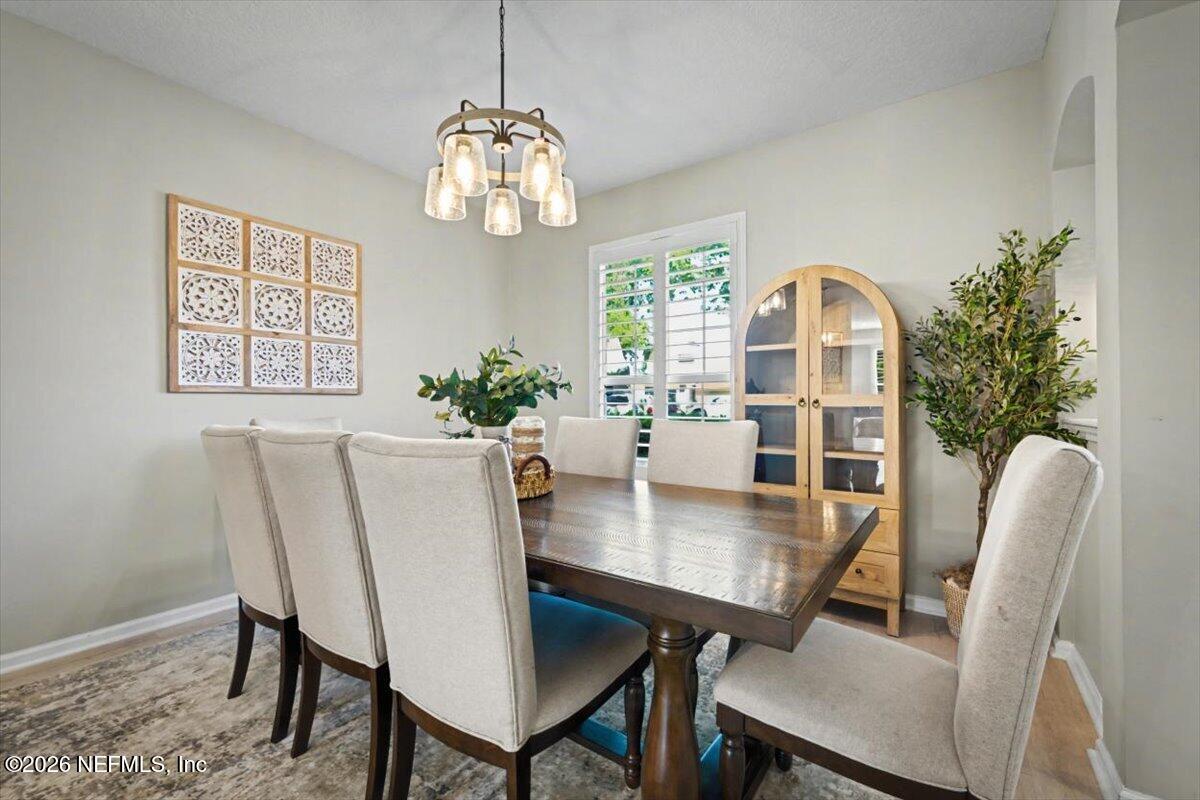 12683 Arrowleaf Lane Jacksonville, FL 32225 - Photo 9 of 52 a view of a dining room with furniture window and wooden floor