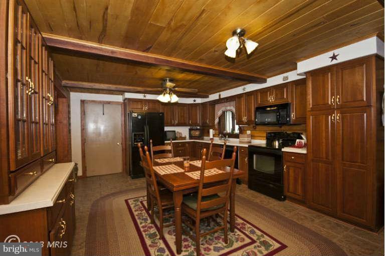 1720 East Deep Run Road Manchester, MD 21102 - Photo 2 of 30 a view of a kitchen with dining area wooden floor and a refrigerator