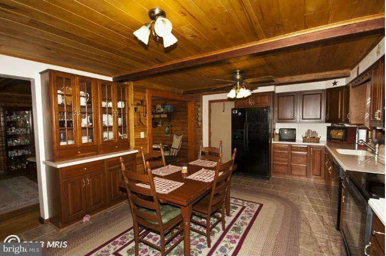 1720 East Deep Run Road Manchester, MD 21102 - Photo 12 of 30 a view of a dining room with furniture a chandelier and wooden floor