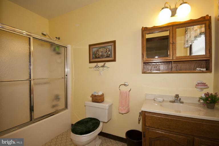 1720 East Deep Run Road Manchester, MD 21102 - Photo 26 of 30 a bathroom with a granite countertop toilet sink and shower