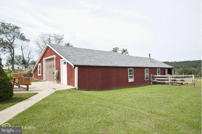 1720 East Deep Run Road Manchester, MD 21102 - Photo 28 of 30 a front view of house with yard and trees in the background