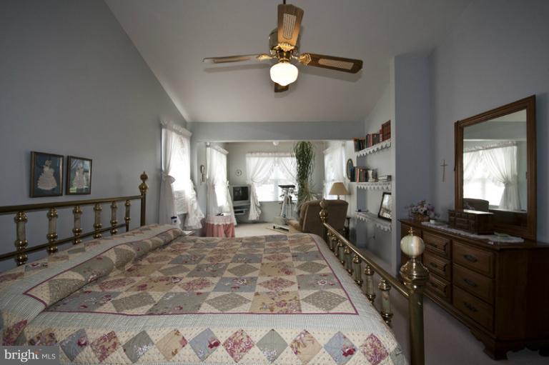 1720 East Deep Run Road Manchester, MD 21102 - Photo 5 of 30 a large bedroom with a bed and a chandelier