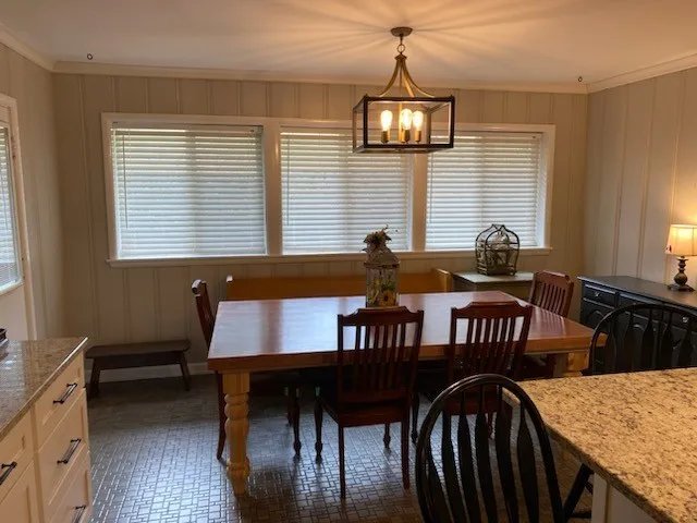 a dining room with furniture and window