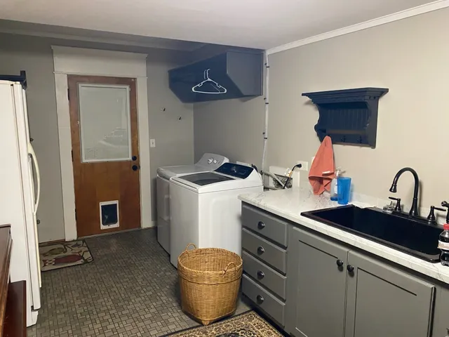 a kitchen with a sink and a stove top oven