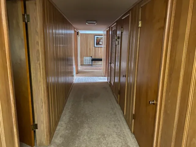a view of a hallway with wooden floor