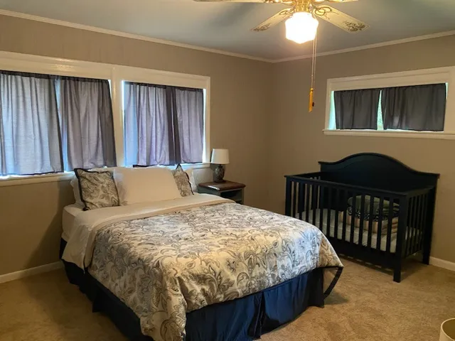 a bedroom with a bed and a chandelier