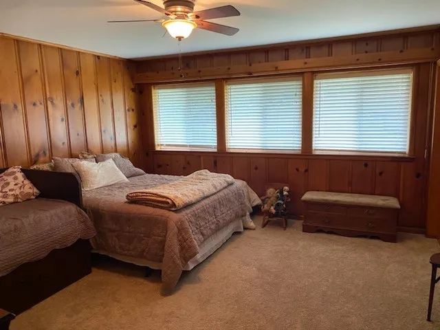 a spacious bedroom with a bed and a couch