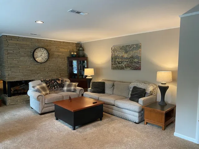 a living room with furniture and a wall painting