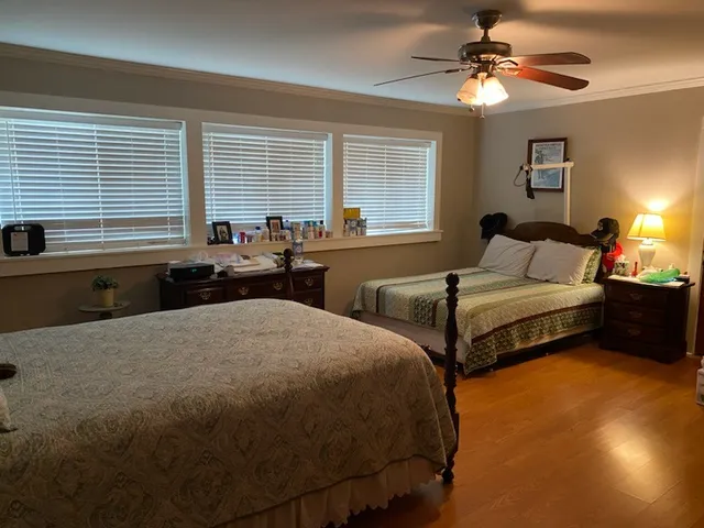 a bedroom with two beds and a chandelier