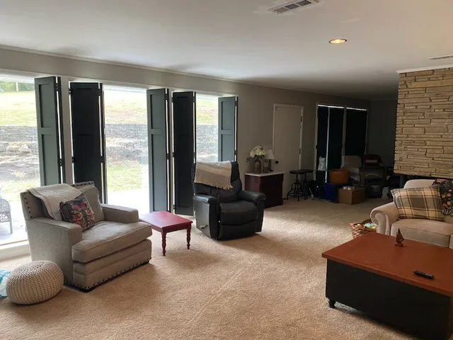 a living room with furniture and large windows