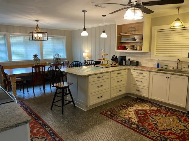 a large kitchen with a table and chairs