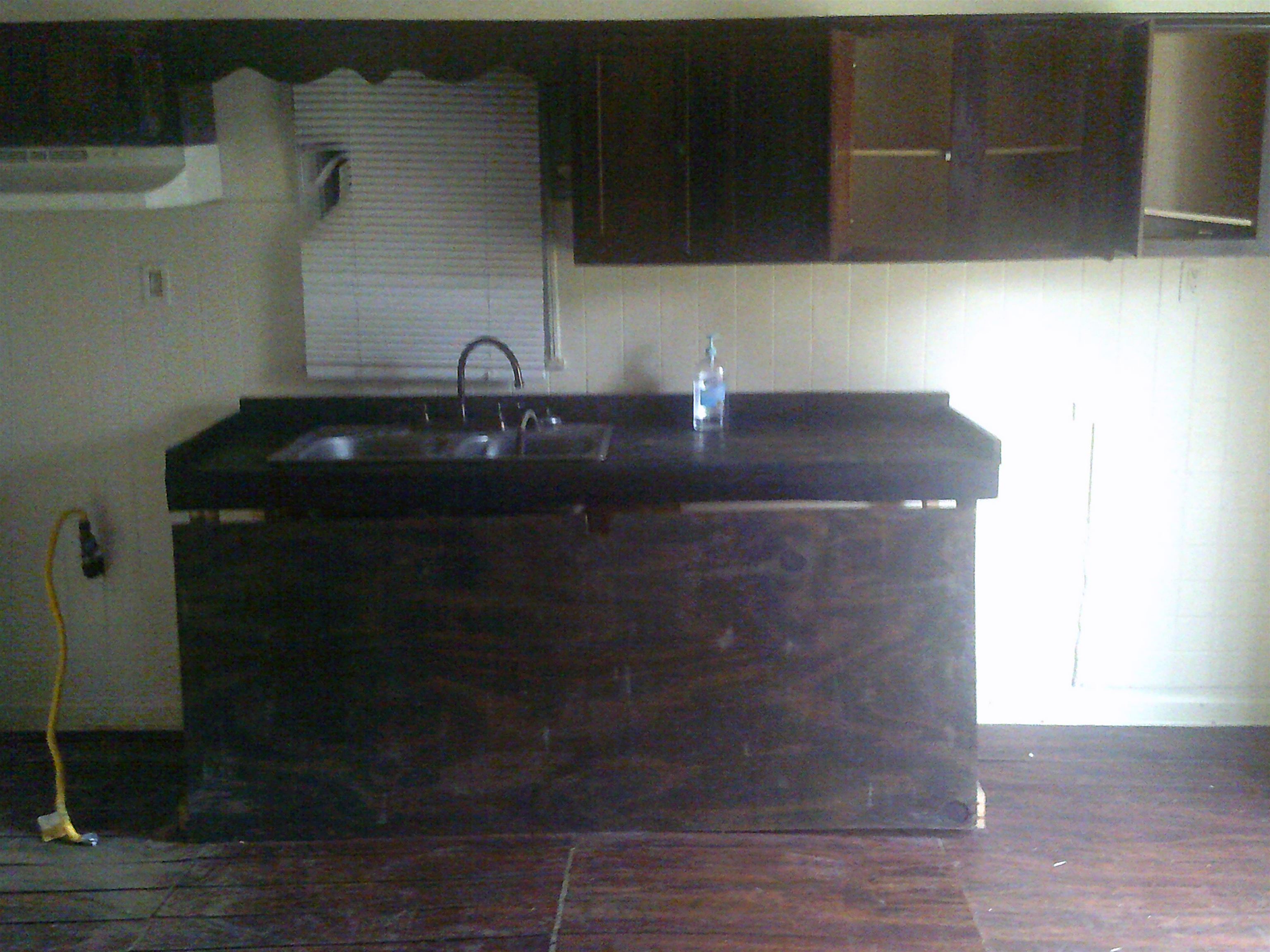 3034 Travis Road Memphis, TN 38109 - Photo 4 of 8 Kitchen with wood finished floors and a sink