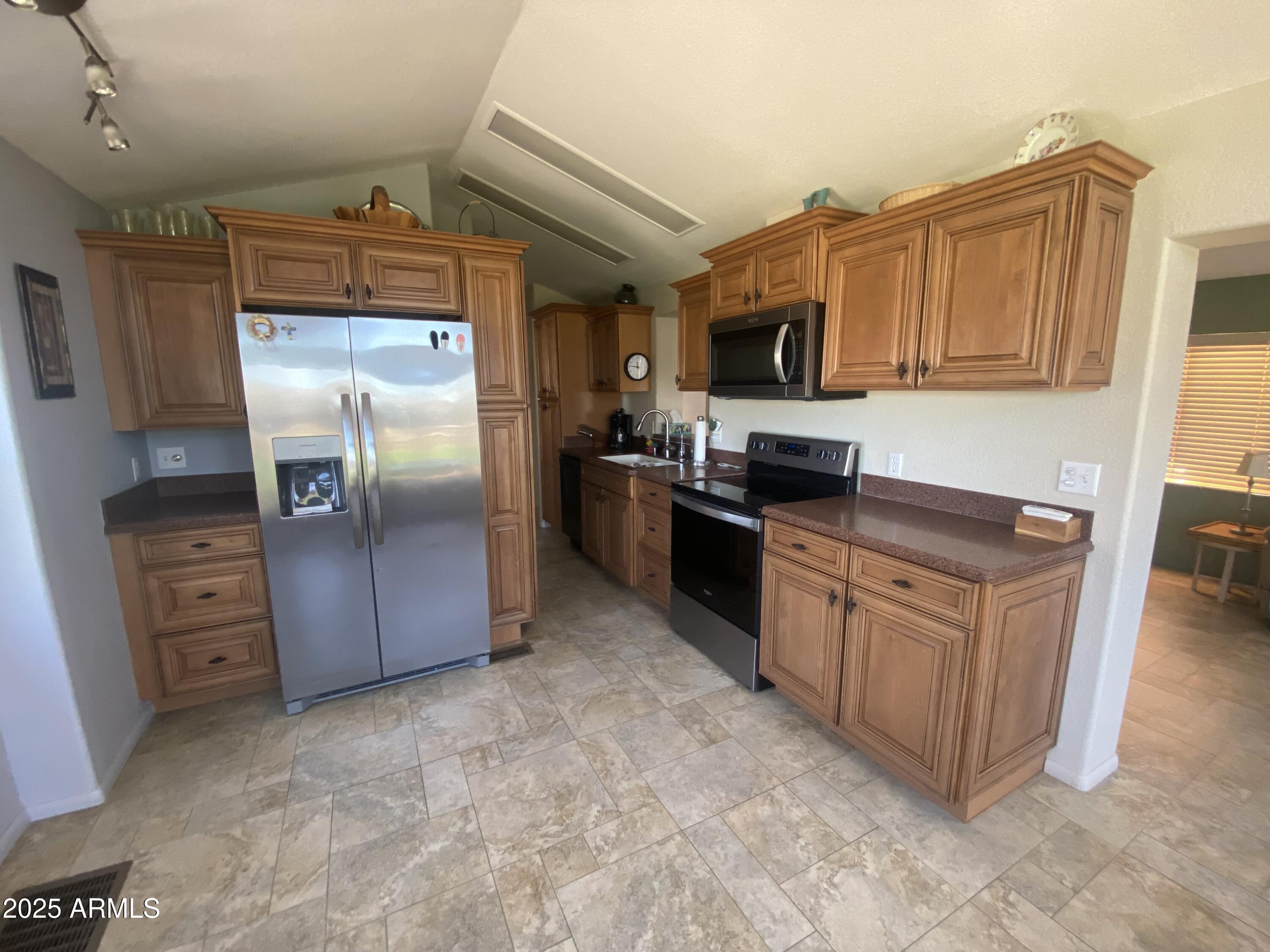 2239 West San Juan Circle Apache Junction, AZ 85119 - Photo 14 of 37 a kitchen with stainless steel appliances granite countertop a refrigerator and a stove