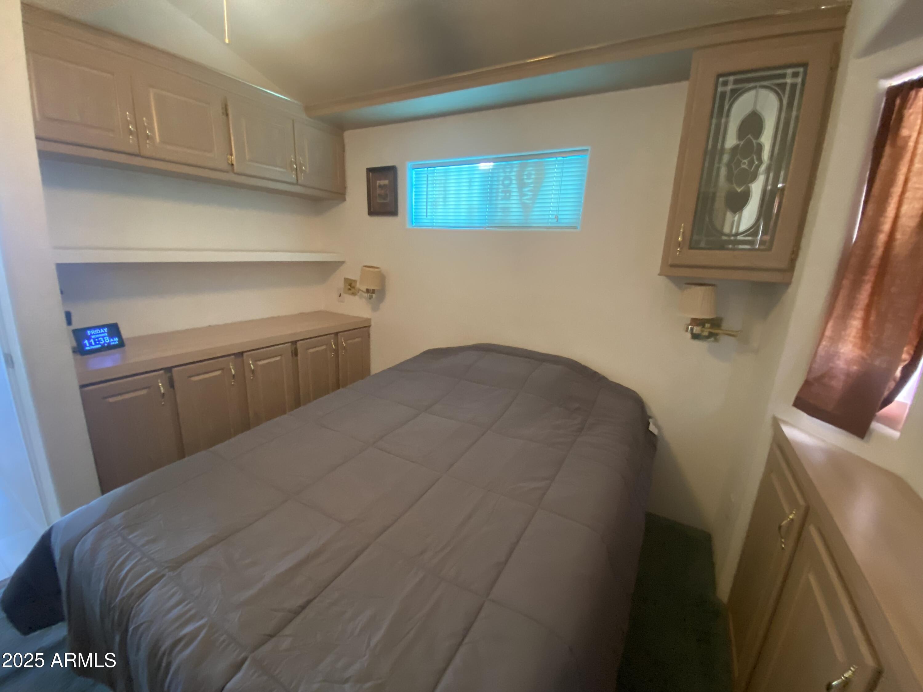 2239 West San Juan Circle Apache Junction, AZ 85119 - Photo 23 of 37 a bedroom with a bed and cabinets