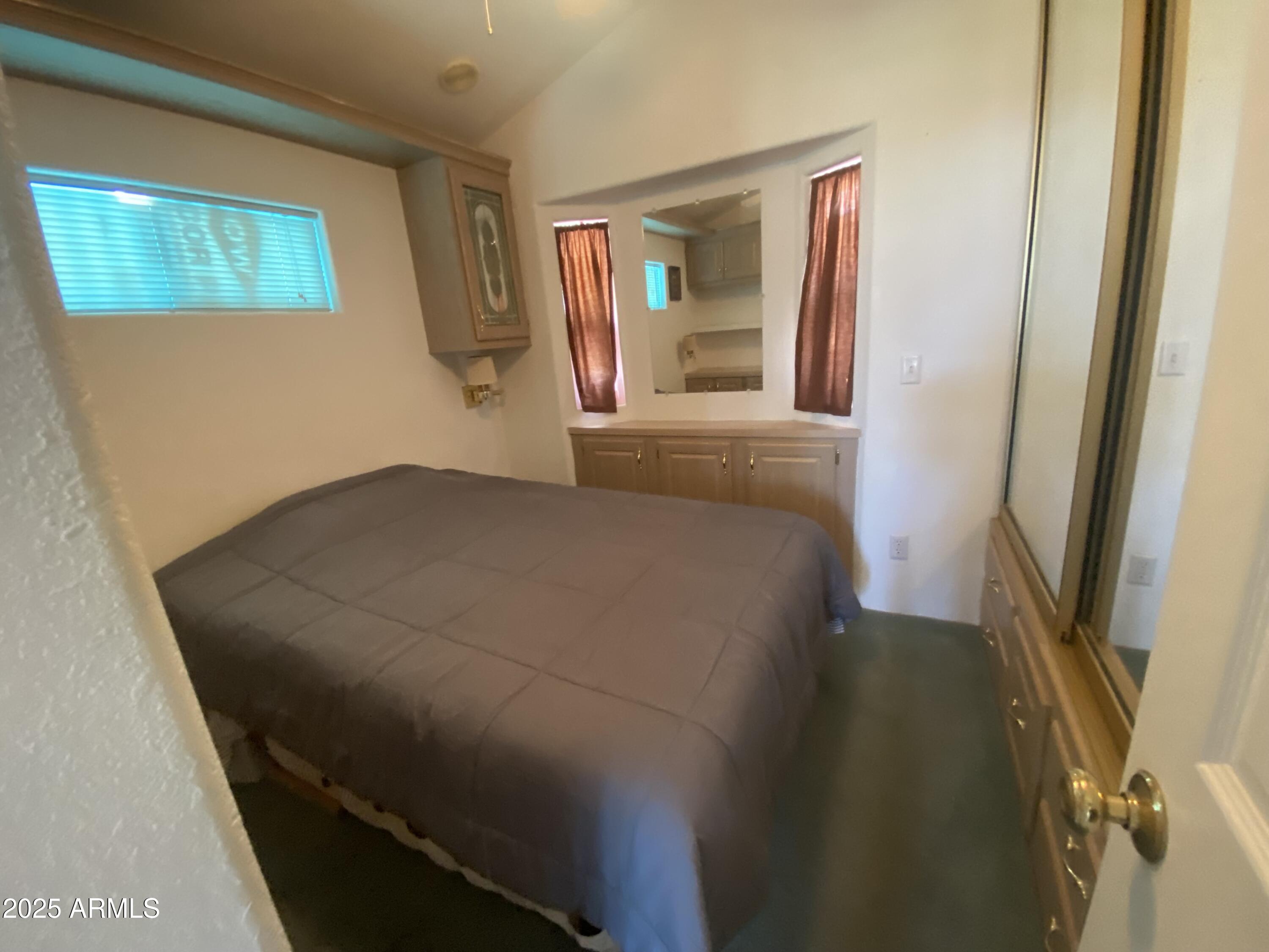 2239 West San Juan Circle Apache Junction, AZ 85119 - Photo 24 of 37 a bedroom with a bed and a mirror