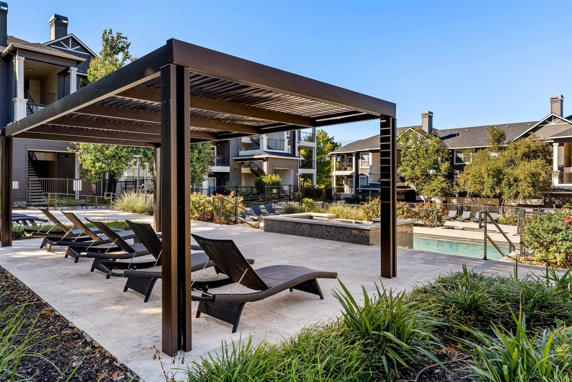 15450 Farm To Market Road 1325 Road, Unit 272726 Austin, TX 78728 - Photo 18 of 18 a view of a patio with a table and chairs under an umbrella