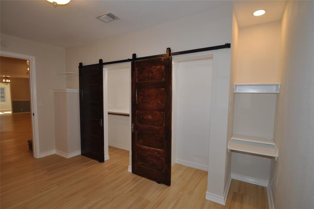 209 West 5th Street Tolar, TX 76476 - Photo 5 of 11 a view of walk in closet with wooden floor