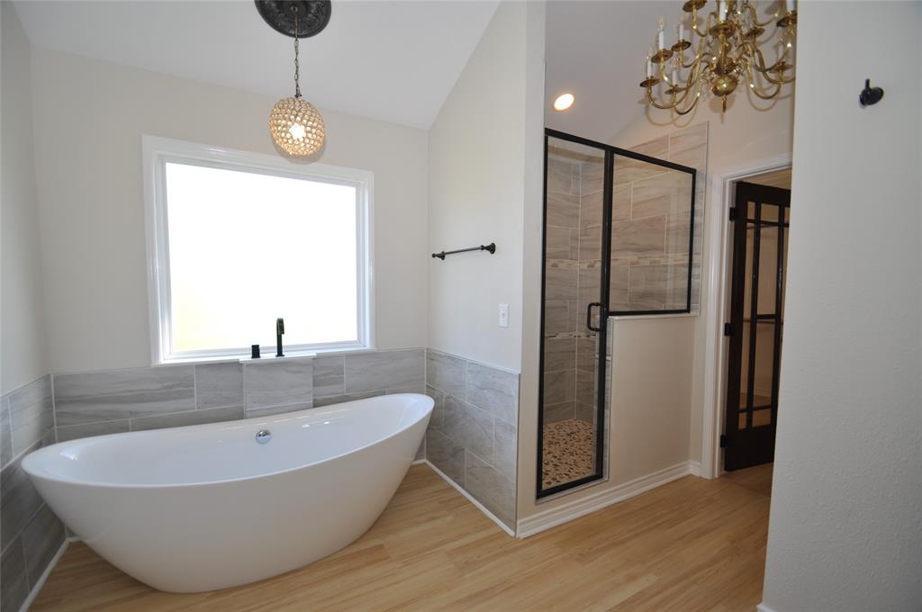 209 West 5th Street Tolar, TX 76476 - Photo 9 of 11 a bathroom with a bathtub and shower