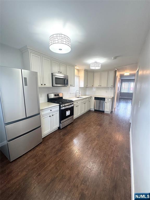 a kitchen with furniture a refrigerator and a stove top oven
