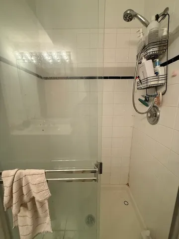 a bathroom with a shower and tub