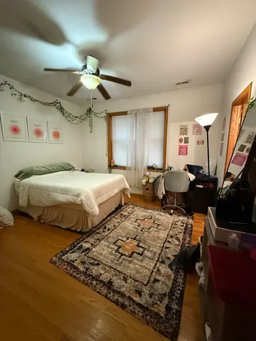 a bedroom with double bed and a chandelier
