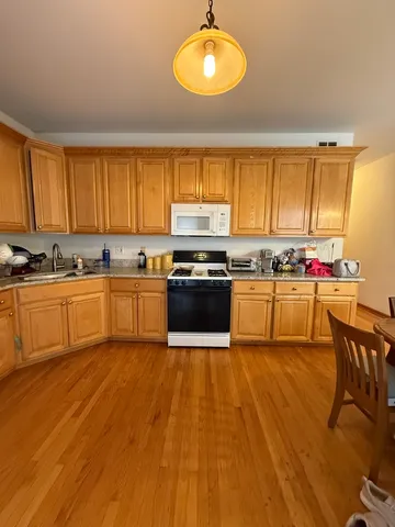 a kitchen with wooden floors and a sink