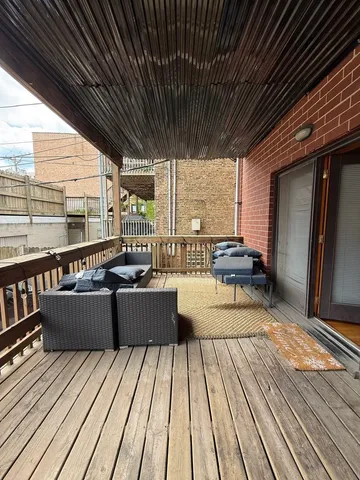 a view of balcony with wooden floor and outdoor seating