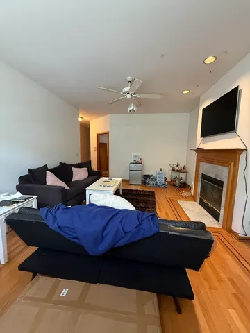 a living room with furniture a flat screen tv and a fireplace