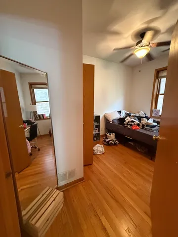 a bedroom with furniture and a mirror