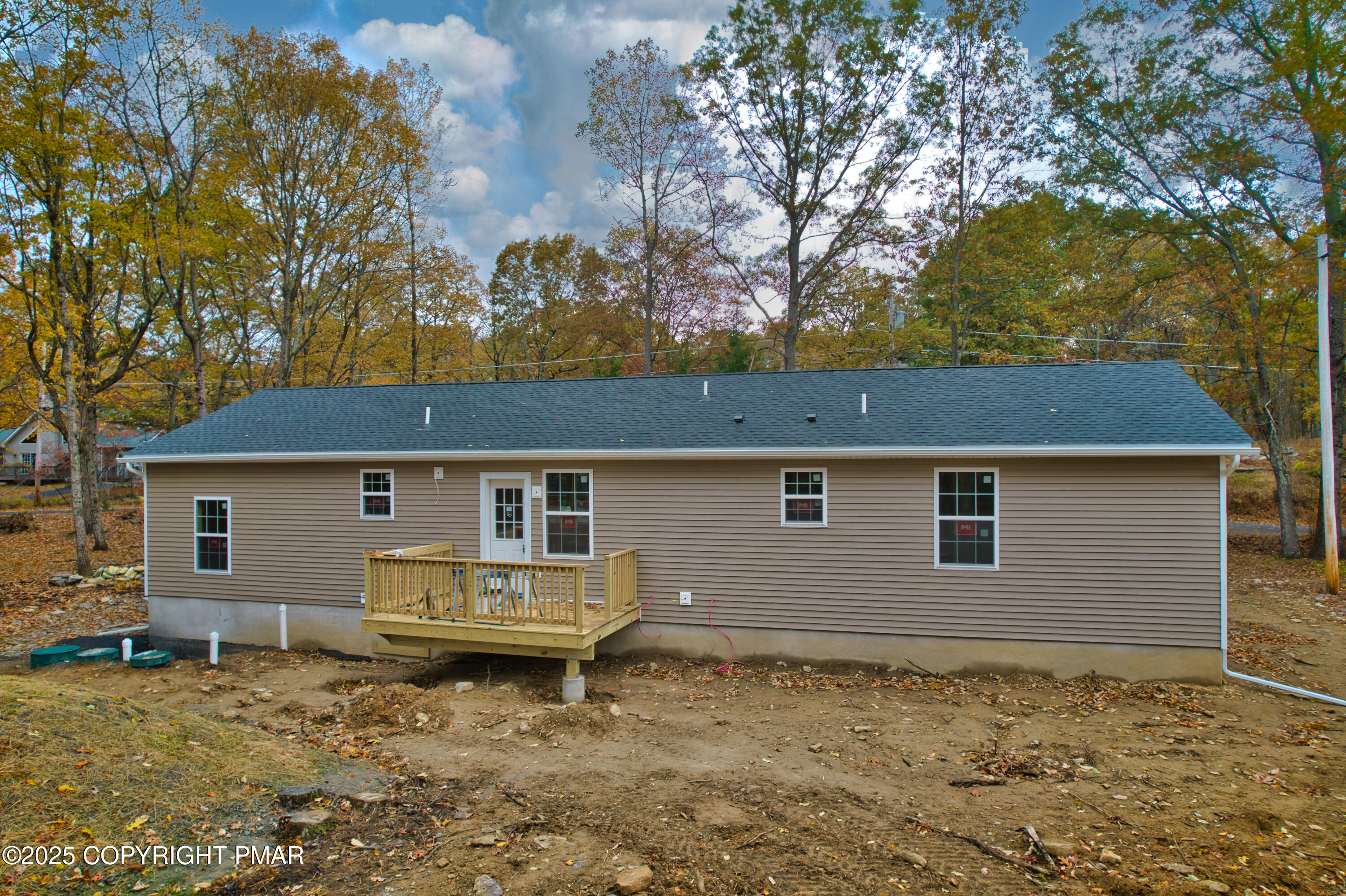 515 Hummingbird Court Bushkill, PA 18324 - Photo 13 of 15 a backyard of house with yard and trees in the background