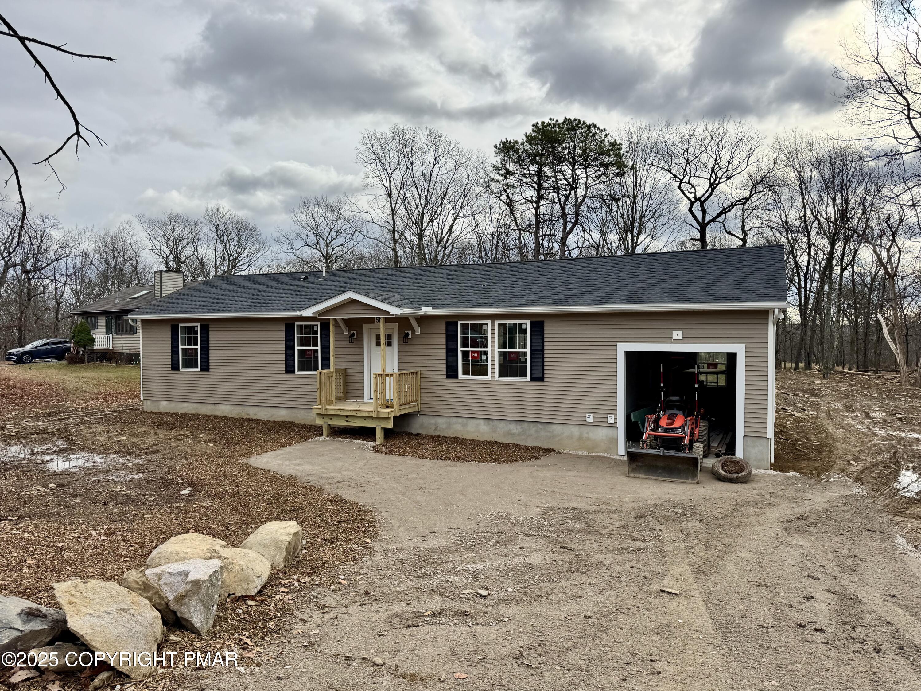 515 Hummingbird Court Bushkill, PA 18324 - Photo 15 of 15 a view of a house with a yard and covered with snow