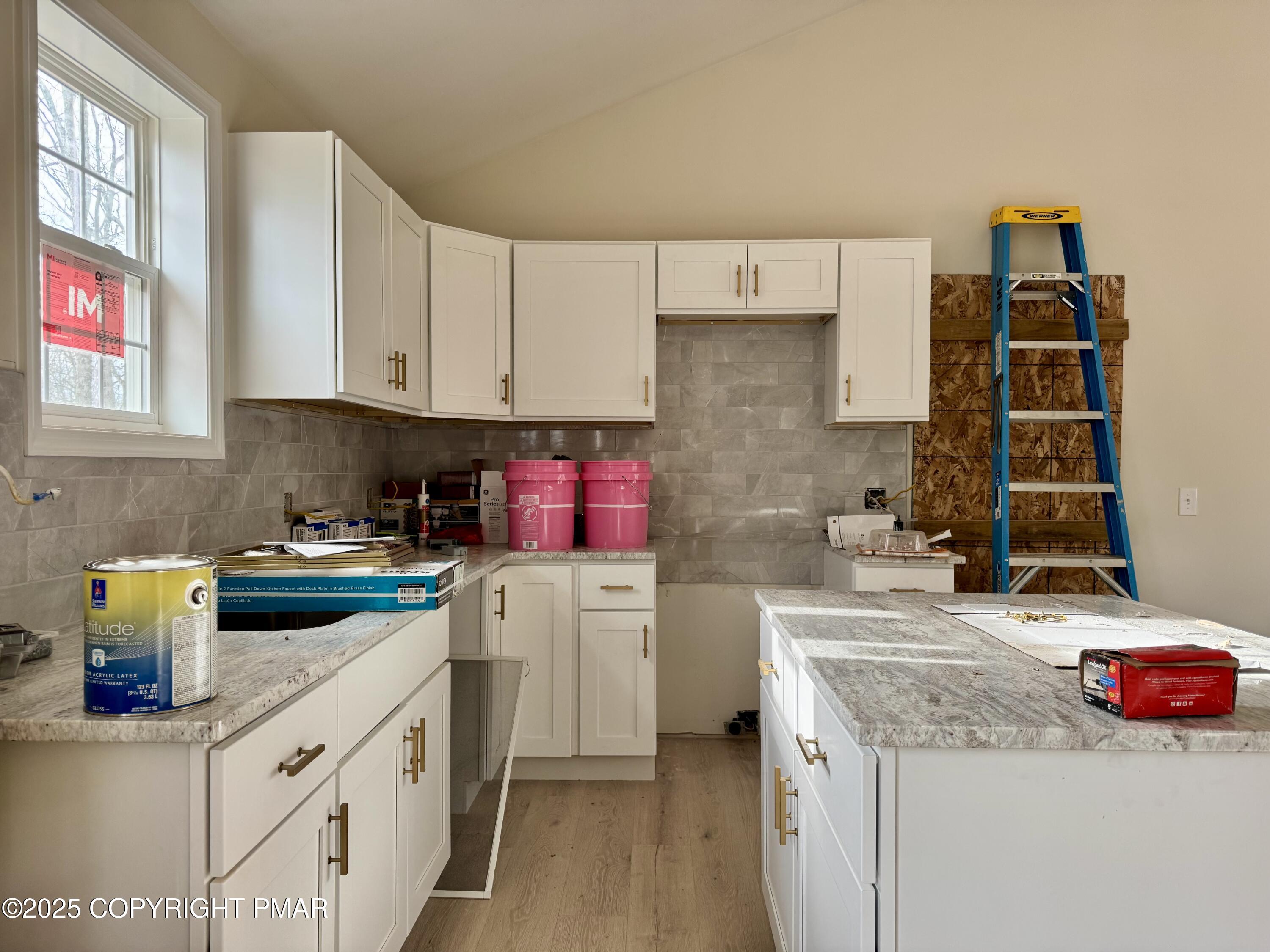 515 Hummingbird Court Bushkill, PA 18324 - Photo 3 of 15 a kitchen with a sink stove and cabinets