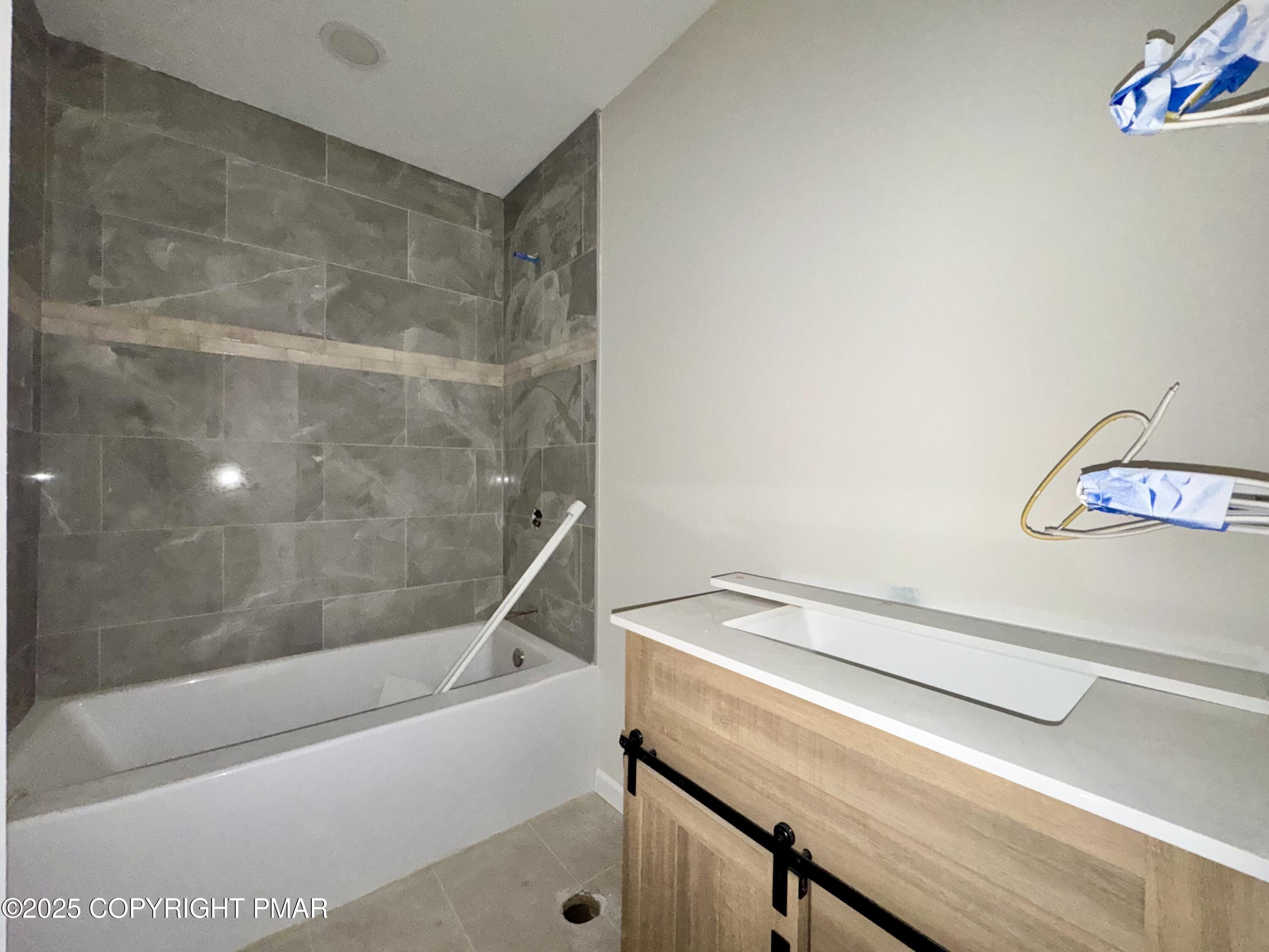 515 Hummingbird Court Bushkill, PA 18324 - Photo 7 of 15 a bathroom with a bathtub and a shower