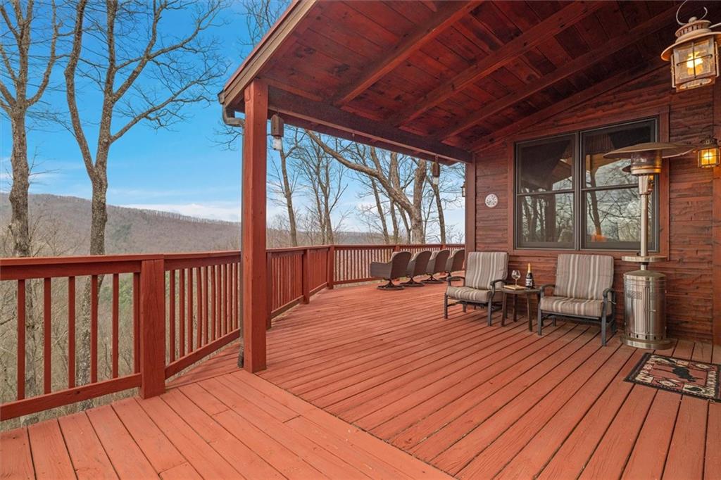 881 Fox Mountain Road Cherry Log, GA 30522 - Photo 11 of 65 a balcony with wooden floor and outdoor seating