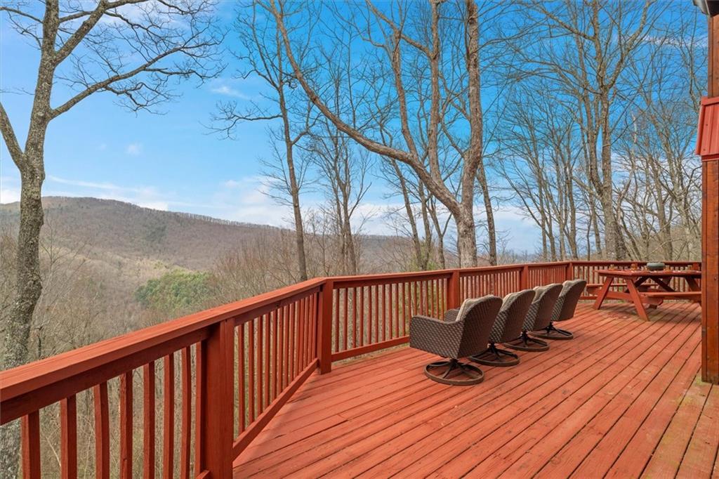 881 Fox Mountain Road Cherry Log, GA 30522 - Photo 12 of 65 a view of balcony with wooden floor and outdoor seating