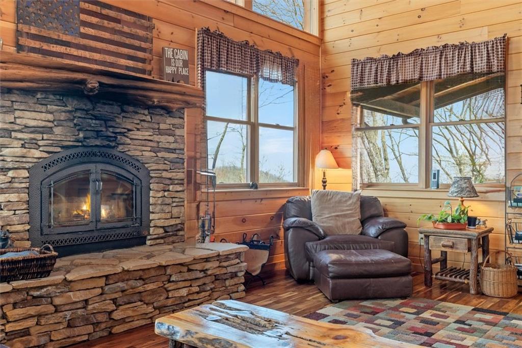 881 Fox Mountain Road Cherry Log, GA 30522 - Photo 24 of 65 a living room with furniture a window and a fireplace
