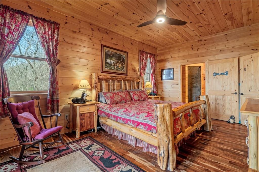 881 Fox Mountain Road Cherry Log, GA 30522 - Photo 33 of 65 a bedroom with a bed and wooden floor