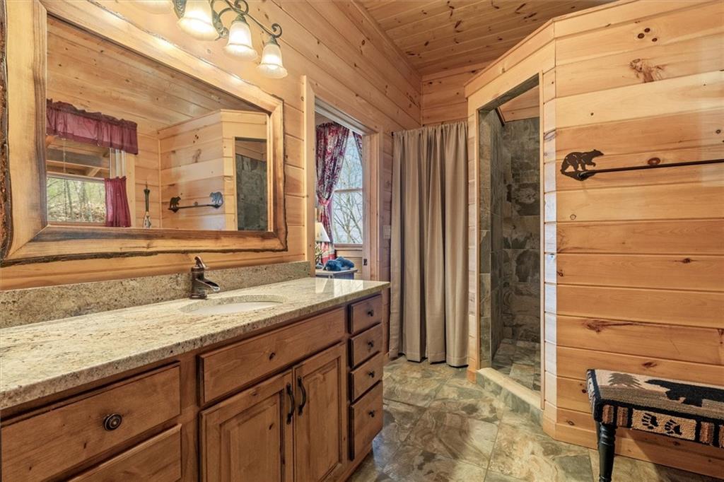 881 Fox Mountain Road Cherry Log, GA 30522 - Photo 34 of 65 a bathroom with a granite countertop sink and a mirror
