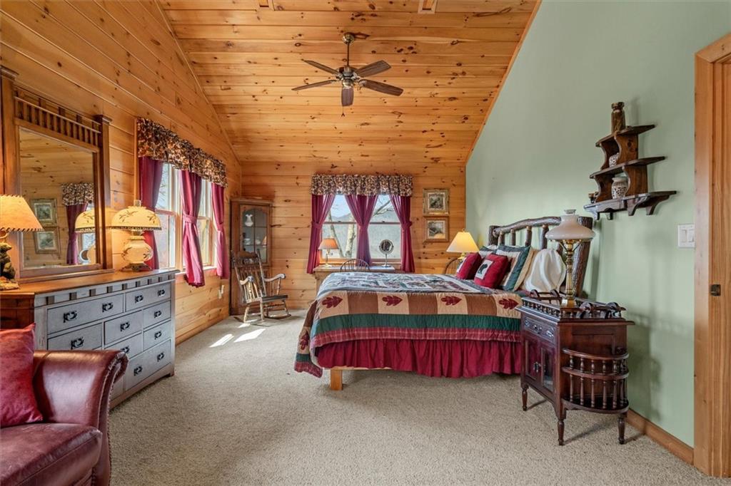 881 Fox Mountain Road Cherry Log, GA 30522 - Photo 45 of 65 a bedroom with furniture and a chandelier