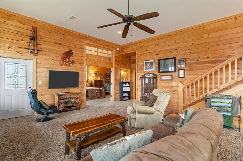 881 Fox Mountain Road Cherry Log, GA 30522 - Photo 50 of 65 a living room with furniture a flat screen tv and a table