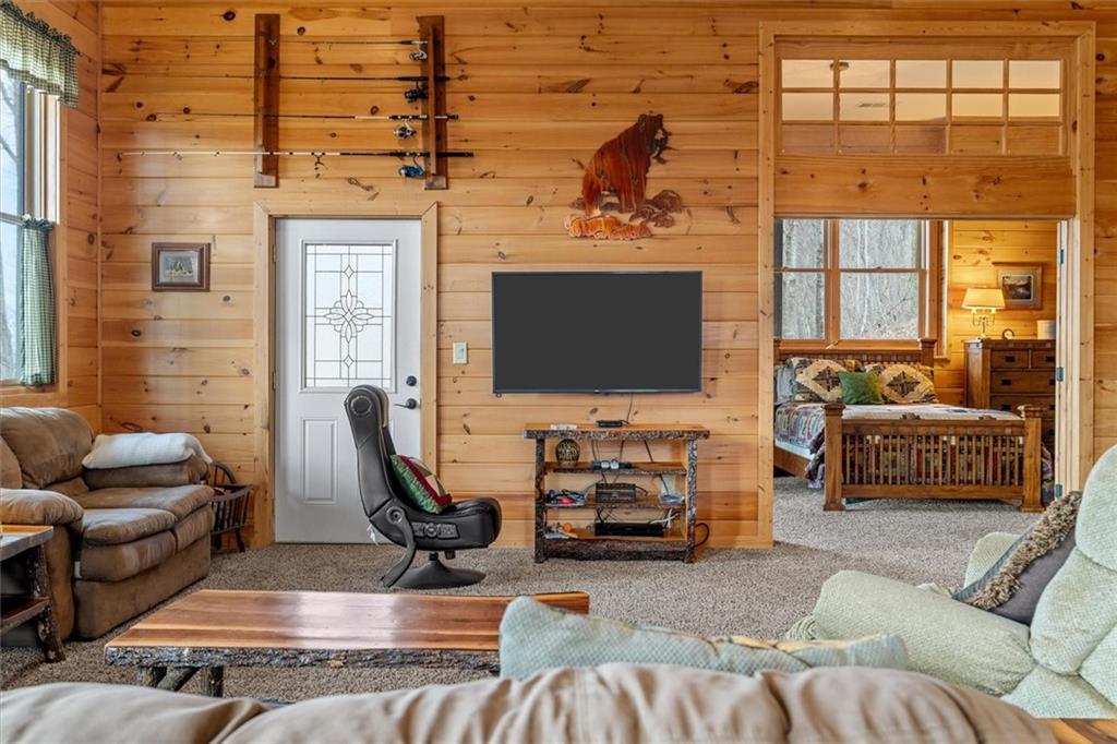 881 Fox Mountain Road Cherry Log, GA 30522 - Photo 51 of 65 a living room with furniture a flat screen tv and a large window