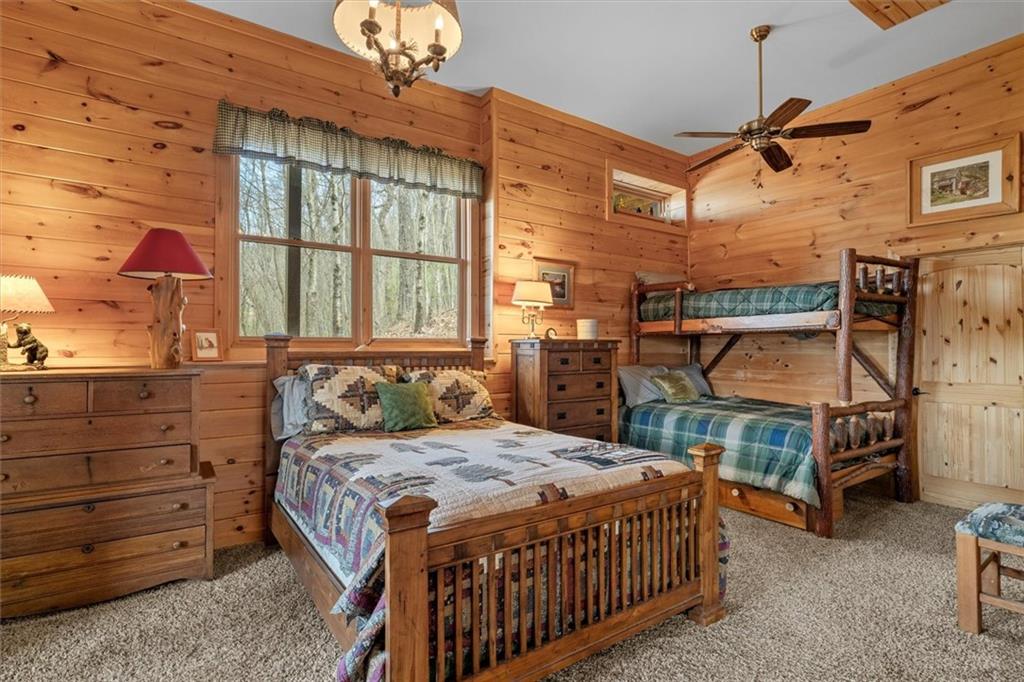 881 Fox Mountain Road Cherry Log, GA 30522 - Photo 57 of 65 a bedroom with a bed and a chandelier