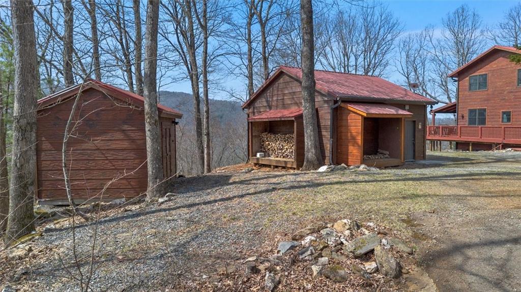 881 Fox Mountain Road Cherry Log, GA 30522 - Photo 9 of 65 a view of a house with a yard and garage