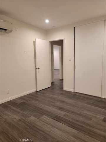 an empty room with wooden floor