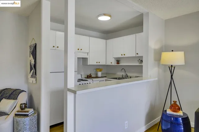 a kitchen with stainless steel appliances granite countertop a refrigerator a stove and white cabinets