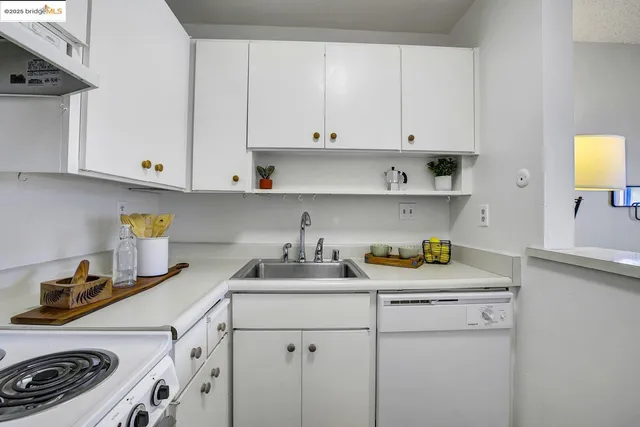 a kitchen with a sink a stove and cabinets
