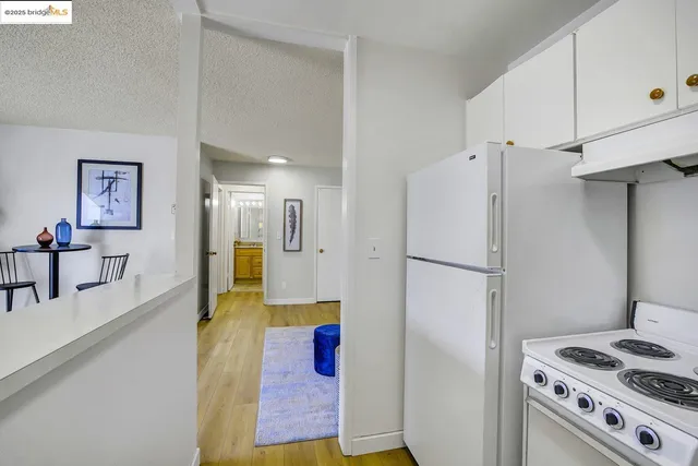 a kitchen with refrigerator a stove and a sink