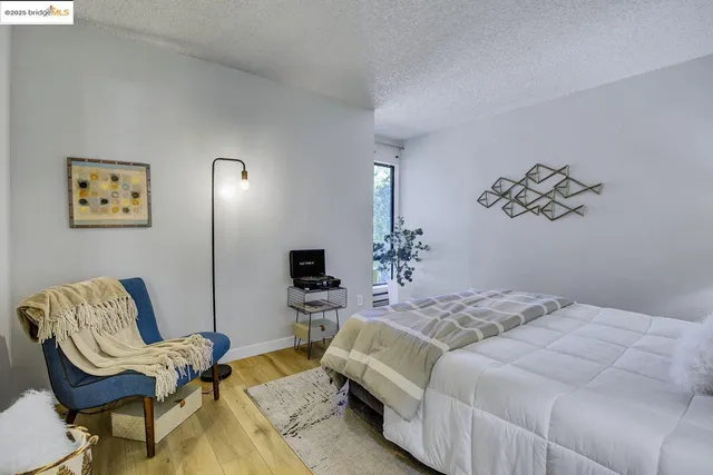 a bed room with a bed and a chair