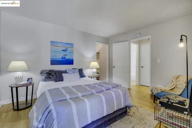 a bedroom with a bed and wooden floor